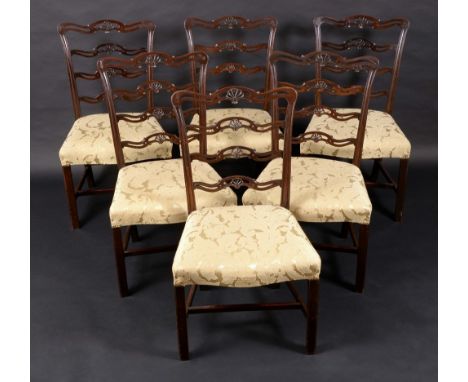 A set of six George III Revival mahogany dining chairs, serpentine ladder backs pierced and carved with anthemions, stuffed-o