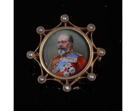 A George VI enamel portrait brooch, painted in full regalia, surrounded by an open eight point frame, each point inset with a