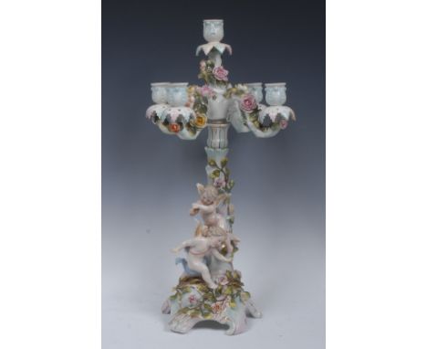 A Sitzendorf four branch five light candelabrum, encrusted with roses, the base with playful cherubs, coloured overall in pas