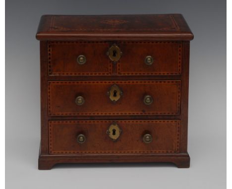 An 18th century walnut miniature chest, slightly oversailing top above three long graduated drawers, inlaid with a lozenge an