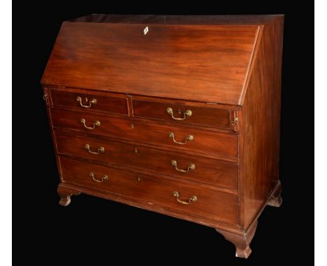 A George III mahogany bureau, fall front enclosing a satinwood veneered arrangement of pigeon holes and small drawers centred