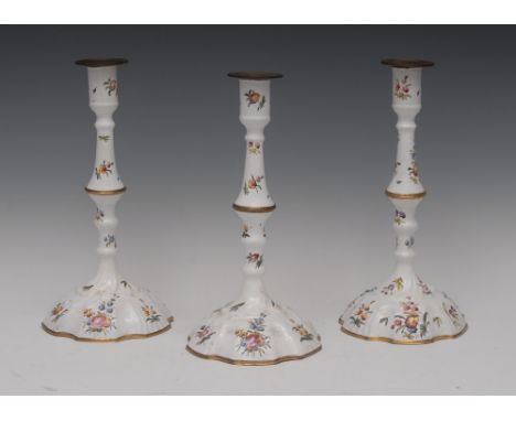 A set of three early George III South Staffordshire enamel candlesticks, of silver form, painted in the deustche Blumen taste