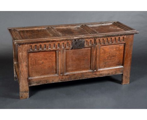 An 18th century oak blanket box, hinged three panel top, fluted friese, stile legs, 61cm high, 129cm wide, c.1740