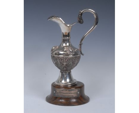 A Spanish silver helmet shaped ewer, lofty scroll handle terminating in acanthus, the filigree body with plain shoulder appli