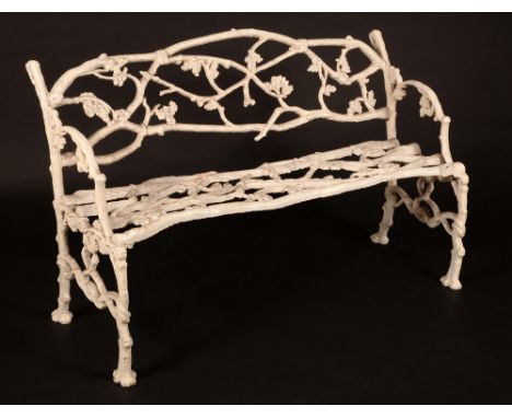 A Victorian cast iron garden bench, attributed to Coalbrookdale, cast throughout with scrolling vine, 127cm wide, c.1860