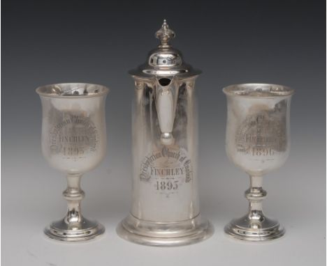 A large Victorian silver cylindrical communion flagon, hinged domed cover with acanthus knop finial, scroll handle, skirted b