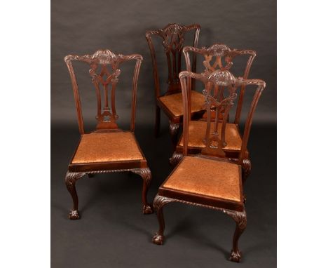 A set of four Chippendale Revival mahogany dining chairs, shaped cresting rails carved with scrolling acanthus, pierced Gothi