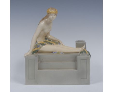 A Royal Worcester figure, of a scantilly draped lady seated with legs stretched on a stepped wall, in flesh tones, olive, blu