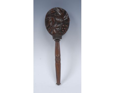 A 19th century Black Forest screw-action nut cracker, the oval drum carved in relief with fruiting vine, the haft with lotus 