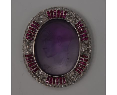 A finely carved amethyst diamond and ruby portrait brooch, central oval amethyst panel carved with a classical maiden facing 