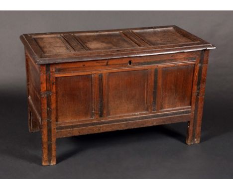 An early 18th century oak three-panel blanket chest, hinged top, stile feet, 62cm high, 101cm wide, c.1700