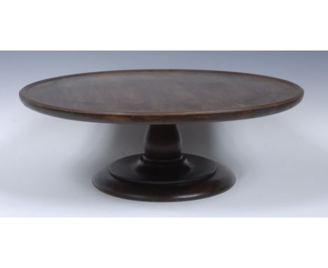 A George III Revival mahogany lazy Susan, quite plain, dished circular rotating top, turned pillar and base, 58cm diam, early