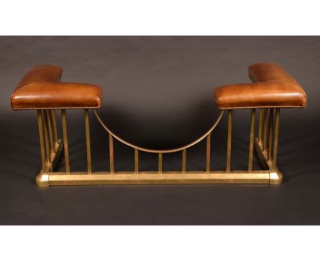 A brass club fender, of typical form with upholstered angles, chamfered base, 145cm wide