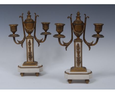 A pair of French Second Empire ormolu and marble two-light cassolette candelabra, each swag-draped urnular central sconce wit