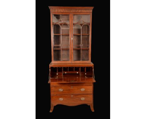 A small Regency mahogany secretaire bookcase, moulded outswept cornice above a deep frieze applied with a band of split-turni