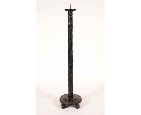 A Chinese bamboo floor standing pricket candle stick, circular top with iron spike, the column pierced and profusely carved w