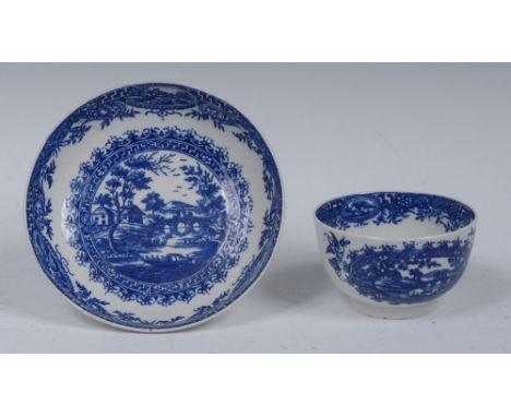 A Worcester Circle Landscape pattern tea bowl and saucer, printed in underglaze blue with landscape within a cartouche, elabo