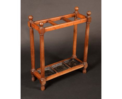 A late Victorian/Edwardian mahogany three-section walking stick stand, sphere finials to angles, turned columns and feet, tin