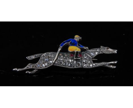 An Edwardian style enamel, diamond and ruby Horse and jockey brooch, the jockey enamelled in blue and yellow racing colours, 