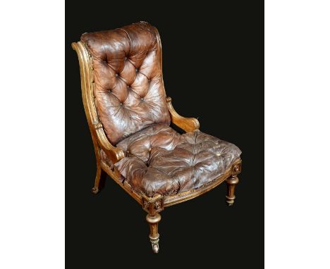 A Victorian walnut nursing chair, deep-button stuffed-over upholstery, bow fronted frieze carved with lotus bosses, turned an