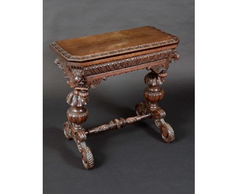 A Victorian 'Jacobethan' canted rectangular oak card table, folding top with acanthus edge enclosing a baize-lined playing su