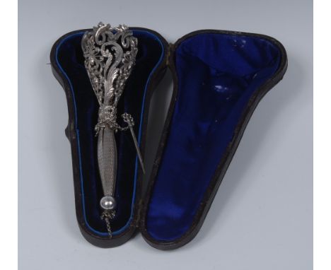 A 19th century silver coloured meal posy holder, pierced and cast with scrolling foliage and leaves, the handle engine turned