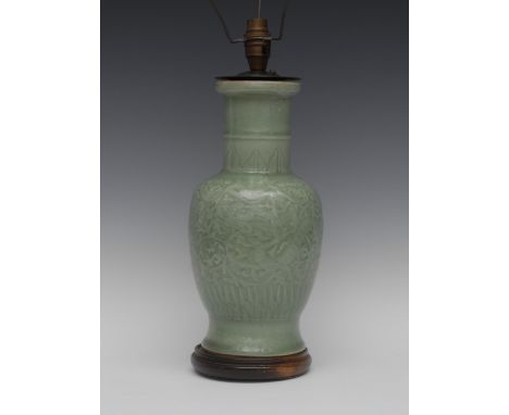 A Chinese celadon roulade vase, moulded with dragons amongst scrolls, beneath a border of lappets, 32cm high, later mounted a