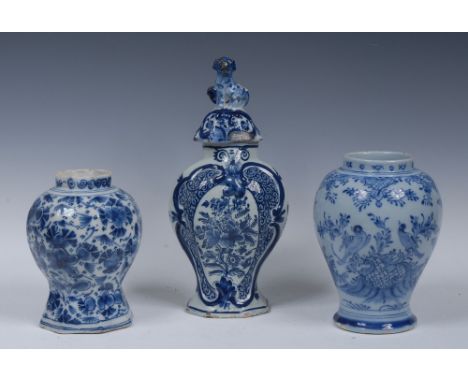 A Delft panelled baluster jar, painted in tones of blue and white with flowers and stylised leaves, 18cm high, painted D mark
