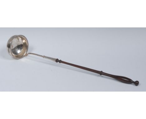 A George III style silver punch ladle, circular bowl with beaded border. turned fruitwood handle, 41cm long, Goldsmiths & Sil