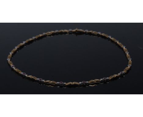 An 18ct gold ruby and diamond fancy link collarette necklace, central seven links each inset with a circular cabochon ruby an