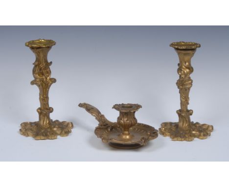 A pair of 19th century French Rococo Revival ormolu candlesticks, cast throughout with flowers and leafy scrolls, 19.5cm high