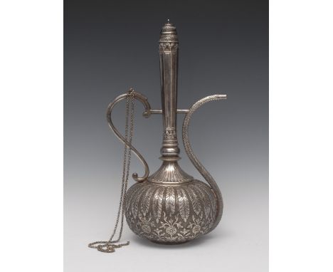 A large Middle Eastern silver ewer, in typical Islamic taste, lofty neck with domed stopper, S-shaped spout, compressed ovoid