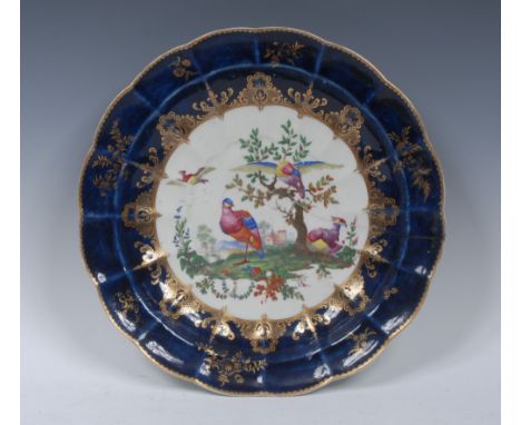 A Worcester shaped circular plate, the centre painted with with exotic birds, standing and in flight, the blue ground with gi