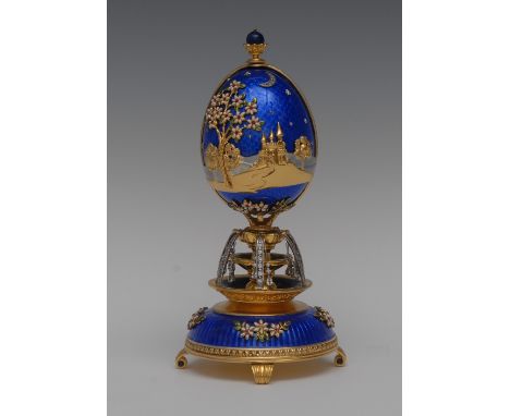 A House of Faberge silver-gilt, enamel and gem set Kingdom of the Unicorn musical egg, by Franklin Mint, applied with castles