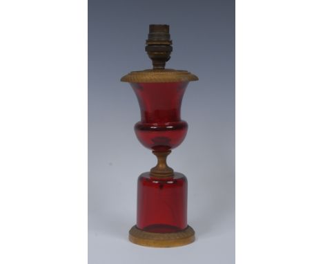 A 19th century ormolu mounted ruby glass table lamp, the top with circular, fluted patera and beaded borders, gadrooned pedes