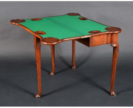 A George II mahogany card table, probably Irish, folding top enclosing a inset baize lined playing surface, counter wells and