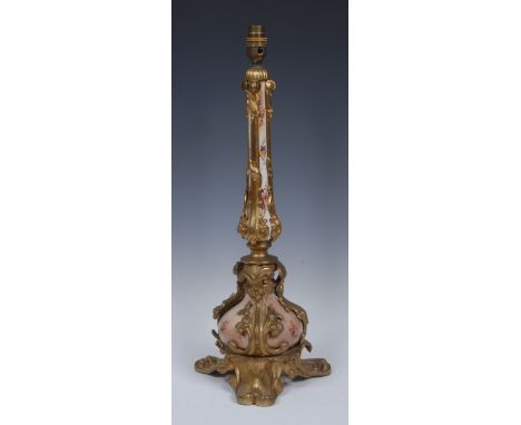 A late 19th century ormolu mounted table lamp, blush ivory vasular neck and reservoir, painted with roses and other country f