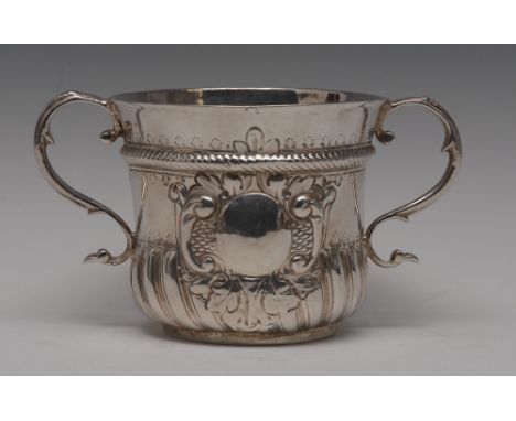 A George I Britannia standard silver half-fluted porringer, flared rim above a chased rope-twist girdle and vacant domed oval