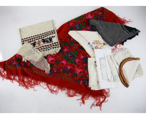 Red ground shawl with floral print and a quantity of linen and cotton napkins and cloths.    