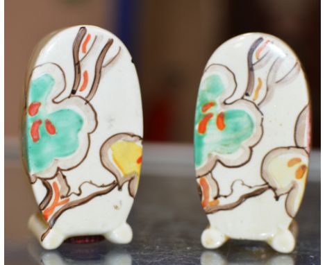 A PAIR OF ART DECO HAND PAINTED SALT &amp; PEPPER CRUETS IN THE STYLE OF CLARICE CLIFF  