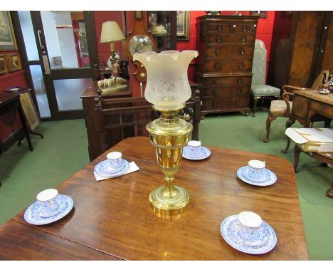 A late Victorian brass oil lamp, the fluted surround to a baluster form base, frosted glass shade 