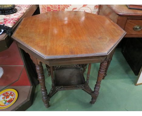 A circa 1900 walnut octagonal top occasional table with galleried undertier and ring turned legs to castors