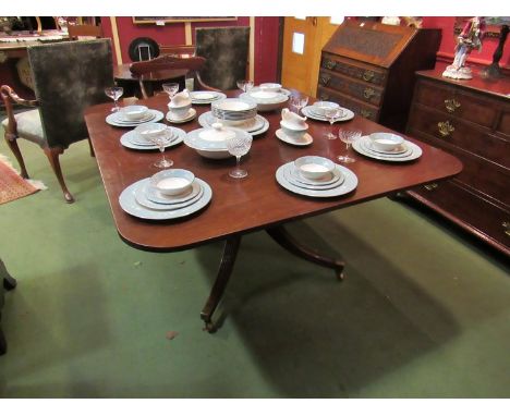 A George III flame mahogany breakfast table, the reeded edge tilt top over a ring turned column on outswept reeded legs and b