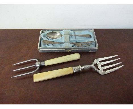 A silver christening set, silver ferruled fork and another