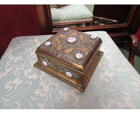 A brass relief trinket box with cherubic painted panels, purple velvet lined interior 