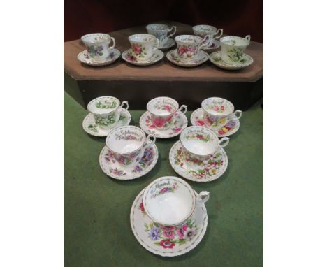 A Royal Albert "Flowers of the Month" set of 12 cups and saucers, white ground with floral sprays 