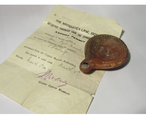 A Roman oil lamp together with documentation from a Cyprus museum 