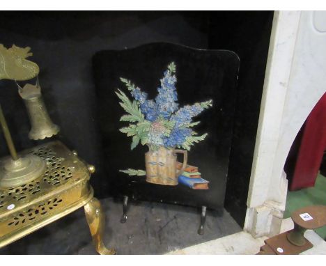 A decorative fire screen with high relief detail of flowers in jug