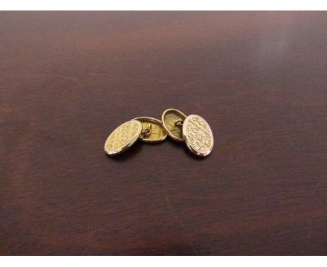 A pair of 9ct gold cufflinks with engine turned design