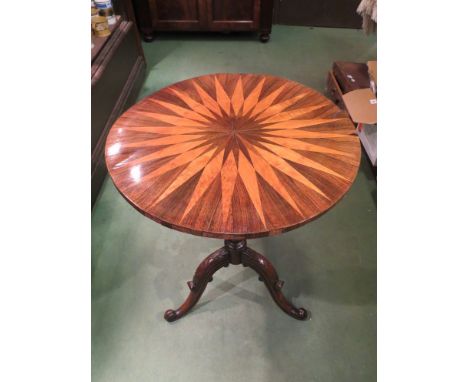 A William IV walnut tilt-top wine table the specimen wood veneered circular top on a turned column and carved scroll foot tri